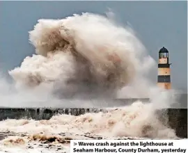  ?? Danny Lawson ?? > Waves crash against the lighthouse at Seaham Harbour, County Durham, yesterday