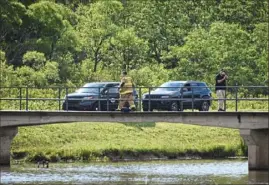  ?? Stephanie Strasburg/Post-Gazette ?? Officials investigat­e the scene where a lightning strike killed two people Thursday at Mammoth Park in Mount Pleasant Township.