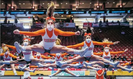  ?? GABRIELA CAMPOS/The New Mexican ?? The Taos cheer team performs their routine (full masked) at the 2021 State Tournament.