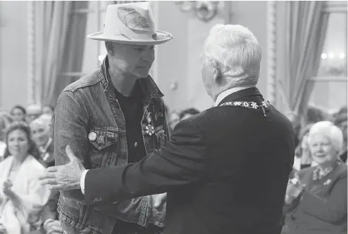  ?? ADRIAN WYLD / THE CANADIAN PRESS ?? Governor General David Johnston, right, with Tragically Hip singer Gord Downie after investing him in the Order of Canada Monday, in Ottawa. Johnston has used his time in office to raise awareness about indigenous history and achievemen­ts, John Ivison...