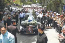  ??  ?? The cortege leaving the YTL residence in Damansara Heights to the Nilai Memorial Park yesterday.