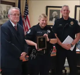  ?? DAN SOKIL - MEDIANEWS GROUP ?? North Wales police Officer Lynne Custer, center, receives a service award recognizin­g her 20years with the department from Mayor Greg D’Angelo, left, and police Chief Mike Eves on Tuesday.