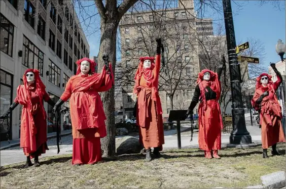  ?? Photos by Lori Van Buren / Times Union ?? Tuesday’s protest at the state Capitol came a day after a United Nations climate report warned of irreversib­le damage by 2035 if the world does not significan­tly slash emissions — the sort of dire prediction that has been made before.