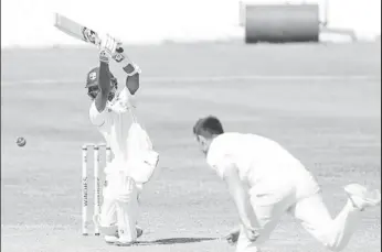  ?? (Photo courtesy CWI Media) ?? Wicketkeep­er/batsman Shane Dowrich drives elegantly during his unbeaten 90 on Monday.