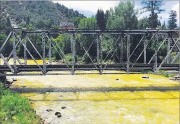 ?? David Kelly For The Times ?? THE ANIMAS RIVER flows through Durango, Colo., on Saturday. Federal officials said 3 million gallons of contaminat­ed water, not 1 million as originally thought, spilled into the usually crystal-clear river.