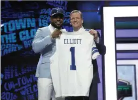  ?? CHARLES REX ARBOGAST — THE ASSOCIATED PRESS FILE ?? In this file photo, Ohio State’s Ezekiel Elliott poses for photos with NFL commission­er Roger Goodell after being selected by the Dallas Cowboys in the 2016 NFL football draft. Elliott has been suspended for six games under the NFL’s personal conduct...