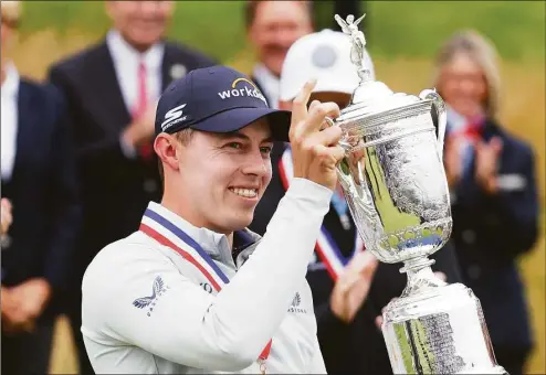  ?? Andrew Redington / Getty Images ?? Matt Fitzpatric­k celebrates with the U.S. Open trophy after winning the U.S. Open at The Country Club Sunday in Brookline, Mass.