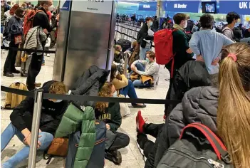  ??  ?? The long wait: Passengers stuck for up to six hours at Heathrow yesterday