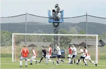  ?? RICK BOWMER/AP ?? A camera films play during an MLS video replay scrimmage last month in Park City, Utah. The games were staged as part of the final training camp to gauge referees’ competence in and comfort with video replay. The league will put video replay into...