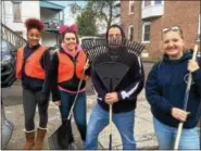  ?? EVAN BRANDT — DIGITAL FIRST MEDIA ?? From left, Pottstown High School freshman Marleigh Rivers, was joined by sophomores Ireland Bray and Jen Hainsey cleaning up North York Street as management informatio­n systems teacher Dave Woodley vainly tried to hide behind a rake