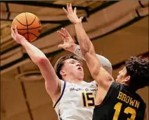  ?? Jenn March / Special to the Times Union ?? Ualbany’s Jonathan Beagle shoots the ball over UMBC’S Dion Brown during their game at Mcdonough Sports Complex in Troy on Wednesday. Beagle finished with 16 points and a season-high 15 rebounds.