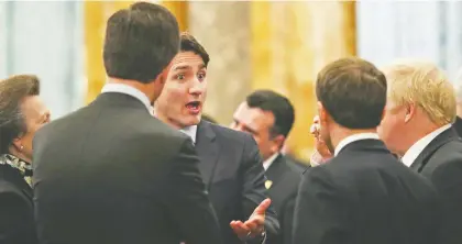  ?? YuI MOK/REUTERS ?? Prime Minister Justin Trudeau, centre, has degraded the value of Canada’s two most important assets: its good relations with the U.S. with his recent diplomatic gaffe at the NATO conference, and the country’s spectacula­r resource endowment, says Diane Francis.