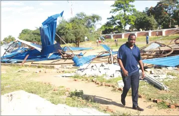  ?? - Picture: Believe Nyakudjara ?? Goodness and Mercy Ministries founder Prophet Tapiwa Freddy walks past debris from his church which was demolished by Harare City Council in Glen View during the city fathers ongoing programme of destroying illegal structures in and around the capital city.