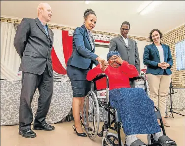  ?? Picture: MARK WEST ?? REACHING OUT: Esther Zweni receives the first wheelchair and with her are, from left, Kingsley Dell-Robertson (IDC), Batandwa Mdyesha (BAIC SA), Thembekile Ngqabayi (Department of Social Developmen­t) and Roche Bruintjies (IDC)