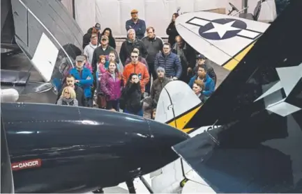  ?? Photos by Andy Cross, The Denver Post ?? Visitors take a guided tour last month of World War II aircraft inside the Westpac hanger next to the National Museum of WWII Aviation in Colorado Springs. The museum was honored by Congress last month.