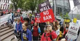  ?? TED S. WARREN / AP ?? Protesters wave signs and chant during a demonstrat­ion against President Donald Trump’s revised travel ban outside a federal courthouse in Seattle. The fate of the travel ban has reached the Supreme Court after two federal courts ruled against it.