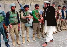  ?? AFP ?? The governor of Bati Kot District of Nangarhar Province Haji Ghalib, who was imprisoned for five years at Guantanamo Bay, speaks with soldiers as he inspects security outposts.