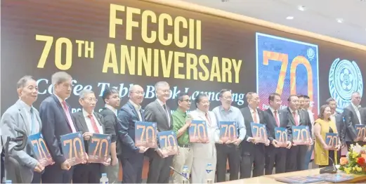  ?? PHOTOGRAPH COURTESY OF FFCCCII ?? CURRENT officials of the Federation of Filipino Chinese Chambers of Commerce and Industry hold a copy of the FFCCCII’s 70th Anniversar­y Coffee Table Book that was launched on Friday at the FFCCCII headquarte­rs in Binondo, Manila.