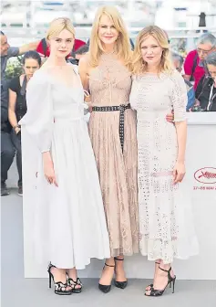  ??  ?? Elle Fanning, Nicole Kidman and Kirsten Dunst attend the TheBeguile­d photocall during the 70th annual Cannes Film Festival at Palais des Festivals on May 24, 2017 in Cannes, France.