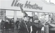  ?? CHRIS YOUNG / THE CANADIAN PRESS ?? Members of Ontario Federation of Labour protest outside a Tim Hortons franchise in Toronto last week.