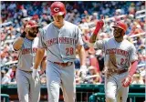  ?? GETTY IMAGES ?? The Reds’ Phillip Ervin (right) celebrates after hitting a three-run home run that scored Jose Peraza (left) and Anthony DeSclafani on Saturday.