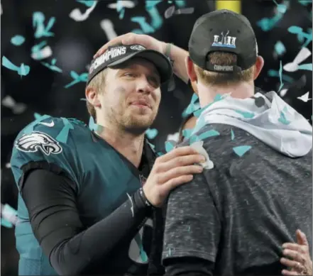  ?? THE ASSOCIATED PRESS FILE ?? Eagles’ Nick Foles, left, celebrates with Carson Wentz after the Super Bowl LII Sunday.