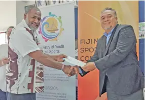  ?? Photo: Kelera Sovasiga ?? Fiji National Rugby League developmen­t officer Joe Dakuitoga (left) receives their Safe Sports accreditat­ion from the director of Youth, Sports and Business Developmen­t Philip Heneriko on August 6, 2020.