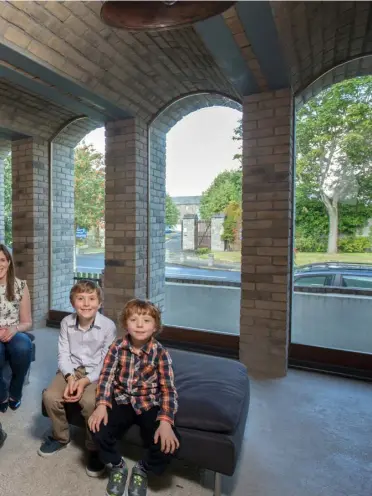  ??  ?? TOP LEFT: Daire’s children, Tadgh and Aoibheann, on the steps — like a stage — of the music room. The masonry stove is built into the bricks. The window faces directly onto the wall of Phoenix Park and one of the front windows is reflected in the...