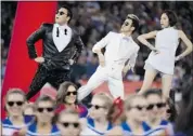  ?? Nathan Denette/canadian Press ?? PSY, left, signs Gangnam Style on stage at the halftime show as the Buffalo Bills play against the Seahawks in Toronto on Sunday.