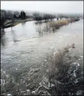  ?? JEFF MULLINS/THE ASSOCIATED PRESS ?? The Humboldt River is swollen far beyond its normally narrow channel as it flows through Elko on Saturday morning.