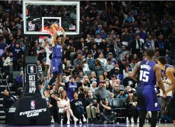  ?? Paul Kitagaki Jr./the Sacramento Bee ?? Kings guard Malik Monk reverse dunks the ball during a game at Golden 1 Center on March 26 in Sacramento. Monk missed the remainder of the regular season after suffering an MCL sprain three days later.