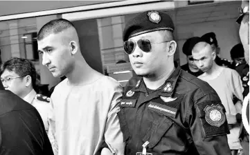  ?? — Bernama photo ?? Mohamed Bilal (back) and Yusufu being escorted by security personnel to the temporary detention at the 11th Military Circle in Dusit district, Bangkok on Nov 24 last year.