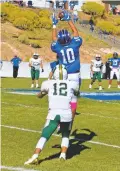  ?? WILL WEBBER/THE NEW MEXICAN ?? St. Michael’s defensive back Joaquin Armijo picks off a pass intended for West Las Vegas receiver Emilio Gonzales in the third quarter of Saturday’s game in Santa Fe. The Horsemen held on for a 27-19 victory.