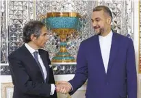  ?? AP ?? Internatio­nal Atomic Energy Organizati­on Director General Rafael Mariano Grossi (left) and Iranian Foreign Minister Hossein Amirabdoll­ahian shake hands before holding talks Saturday.