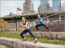  ?? JAMIE HESS VIA AP ?? Jamie and George Hess working out together in New York City. It’s tempting to blow off a workout, but getting sweaty with your significan­t other makes a workout more fun and ups the intensity ante.