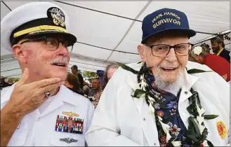  ?? Audrey McAvoy / Associated Press ?? Ira Schab, 102, right, who survived the attack on Pearl Harbor as a sailor on the USS Dobbin, talks with reporters while sitting next to his son, retired Navy Cmdr. Karl Schab, Wednesday.