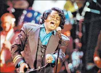  ?? The Associated Press file ?? James Brown sings “Living in America” in June 1991 at the Wiltern Theater in Los Angeles. Legal wrangling over Brown’s estate has been ongoing since his 2006 death.