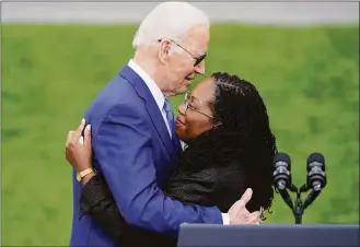  ?? Andrew Harnik / Associated Press ?? President Joe Biden hugs Judge Ketanji Brown Jackson after she spoke at an event on the South Lawn of the White House in Washington on Friday, celebratin­g the confirmati­on of Jackson as the first Black woman to reach the Supreme Court.