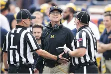  ?? GREGORY SHAMUS/GETTY IMAGES ?? Michigan head coach Jim Harbaugh talks to the refs in Saturday’s game against the Maryland Terrapins in Ann Arbor.