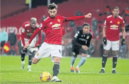  ??  ?? SUBLIME STRIKE: Manchester United’s Bruno Fernandes scores their second goal against Aston Villa from the penalty spot during the match at Old Trafford.