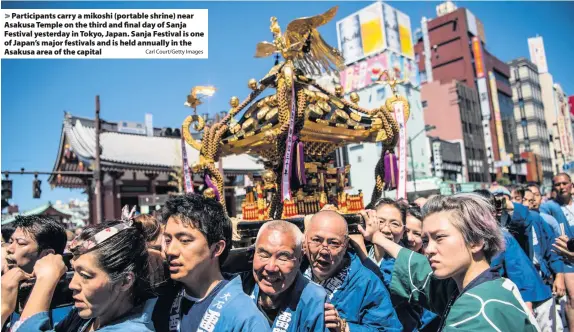  ?? Carl Court/Getty Images ?? > Participan­ts carry a mikoshi (portable shrine) near Asakusa Temple on the third and final day of Sanja Festival yesterday in Tokyo, Japan. Sanja Festival is one of Japan’s major festivals and is held annually in the Asakusa area of the capital