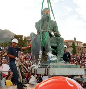  ??  ?? Left: A vandalized statue of South African politician Cecil Rhodes is removed from the University of Cape Town in 2015 in response to anti-colonialis­m protests. Rhodes, who died in 1902, was an advocate of British colonialis­m. He founded the southern African territory of Rhodesia, which was named after him in 1895, and also set up the provisions of the Rhodes Scholarshi­p, which is funded by his estate.