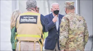  ?? Mandel Ngan / Getty Images ?? President Joe Biden and first lady Jill Biden, left, visit a FEMA COVID-19 vaccinatio­n facility at NRG Stadium in Houston on Friday.