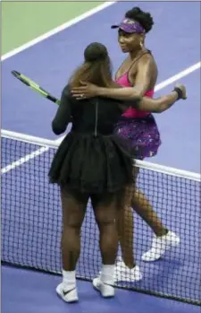  ?? JULIO CORTEZ — THE ASSOCIATED PRESS ?? Serena Williams, left, hugs her sister Venus after defeating her during the third round of the U.S. Open on Friday night in New York.
