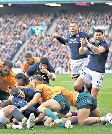  ?? ?? First down: The Scotland players celebrate after Hamish Watson grounds the ball for their opening try against Australia