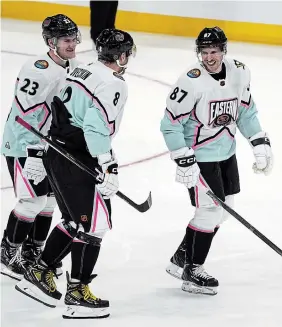  ?? MARTA LAVANDIER THE ASSOCIATED PRESS ?? Sidney Crosby shares a laugh with Metropolit­an Division teammates Alex Ovechkin, centre, and Adam Fox on Saturday at the NHL All-Star Game.