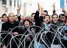  ?? | AFP ?? TUNISIANS protest in front of the prime minister’s offices in Tunis in January, 2011. Africa’s leaders should pay heed to the factors that triggered the Tunisian Revolution and put in place measures to prevent social, economic and political upheaval as the country faces further challenges from the fallout of the Russian/ukaraine conflict, says the writer.