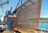  ?? PHOTO: JOHN HAWKINS/ STUFF ?? Peter Leask, skipper of the oyster boat Torea, checks the steel mesh oyster dredging net is ready for the opening morning of the oyster season in Bluff.