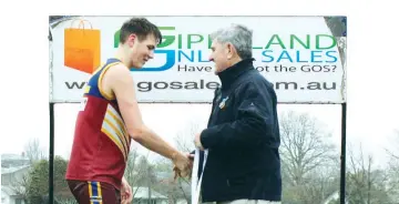 ??  ?? Receiving his medal for best on ground in the under 16 grand final from EDFL board chair Roger Gwynne is Warragul Industrial­s player Brayden Hefford.