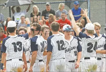  ??  ?? Weston Beagles (24) prepars the homerun chain for Caleb Hopkins (center) after the senior’s solo shot in Game 1 against Bowdon. The Trojans swept the Red Devils to advance to the Class 1A public school state championsh­ip series in Savannah. (Photo by...